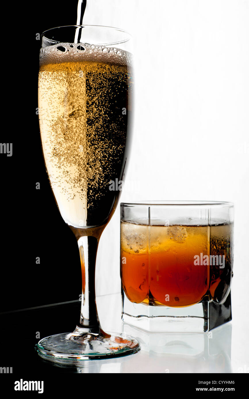 Glass of champagne and whisky with ice. A black and white background Stock  Photo - Alamy
