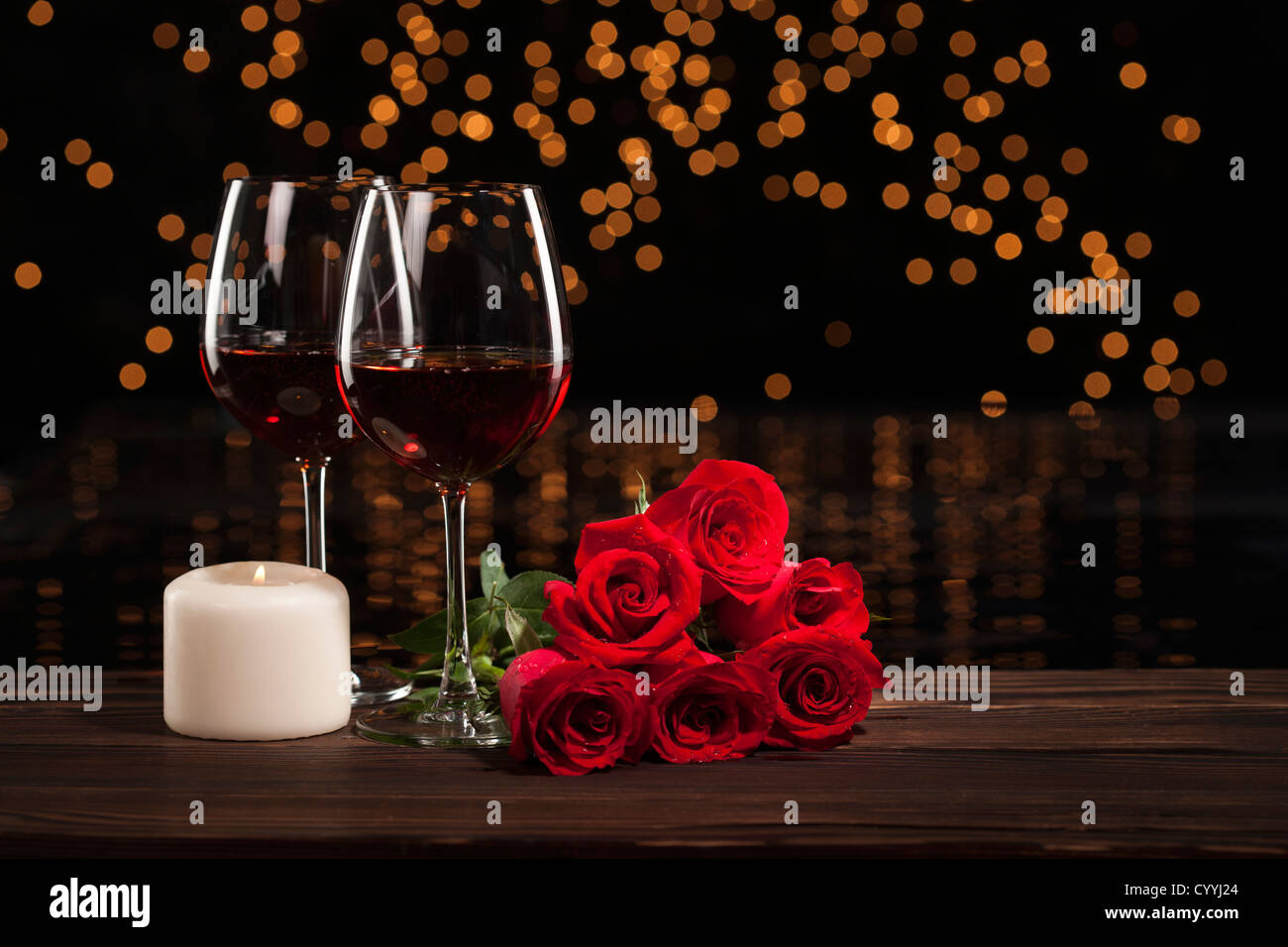 Romantic red wine, roses and white candle Stock Photo - Alamy