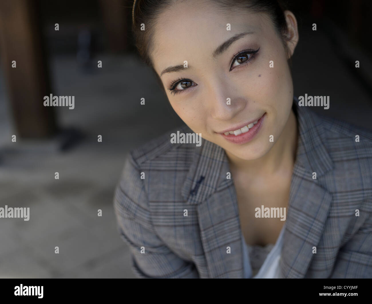 Beautiful young Japanese woman in tweed jacket Stock Photo