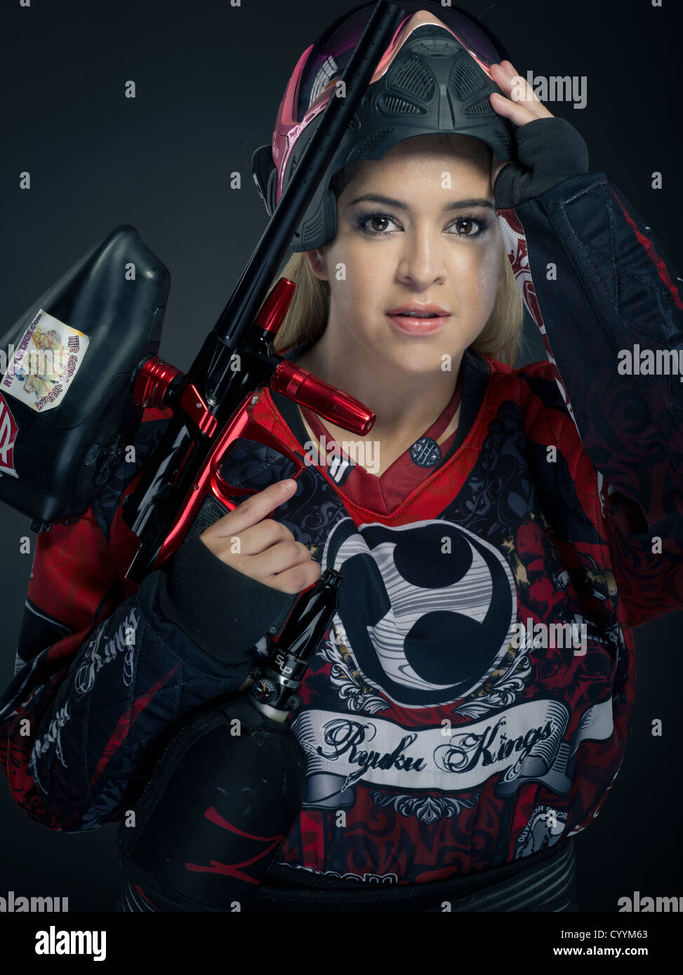 Woman Paintballer with paintball gun and body armor Stock Photo