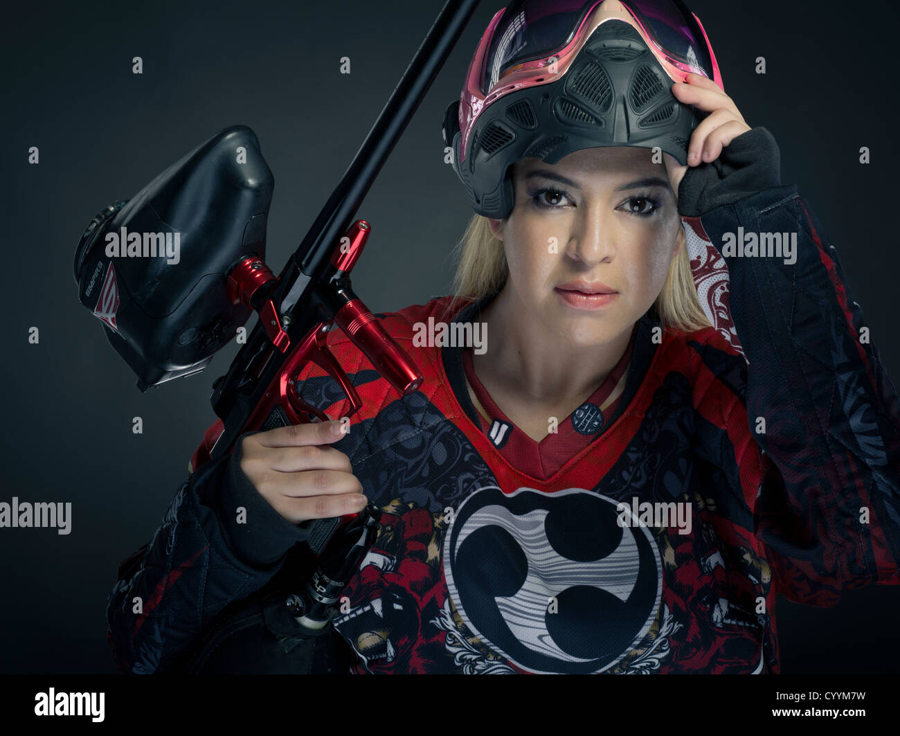Woman Paintballer with paintball gun and body armor Stock Photo Alamy