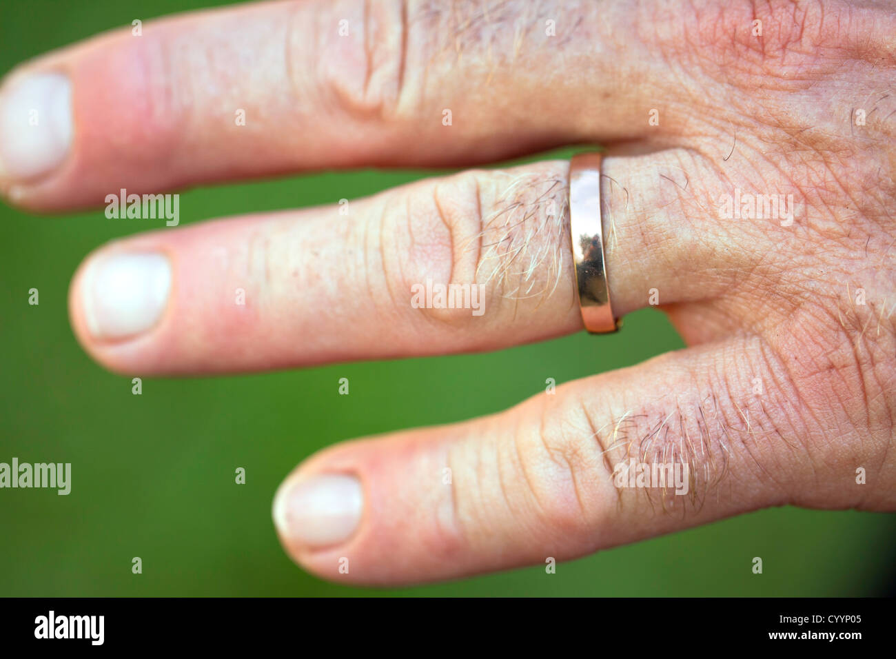 Close up of man's hands with wedding ring on finger. Man twisiting wedding  ring Stock Photo - Alamy