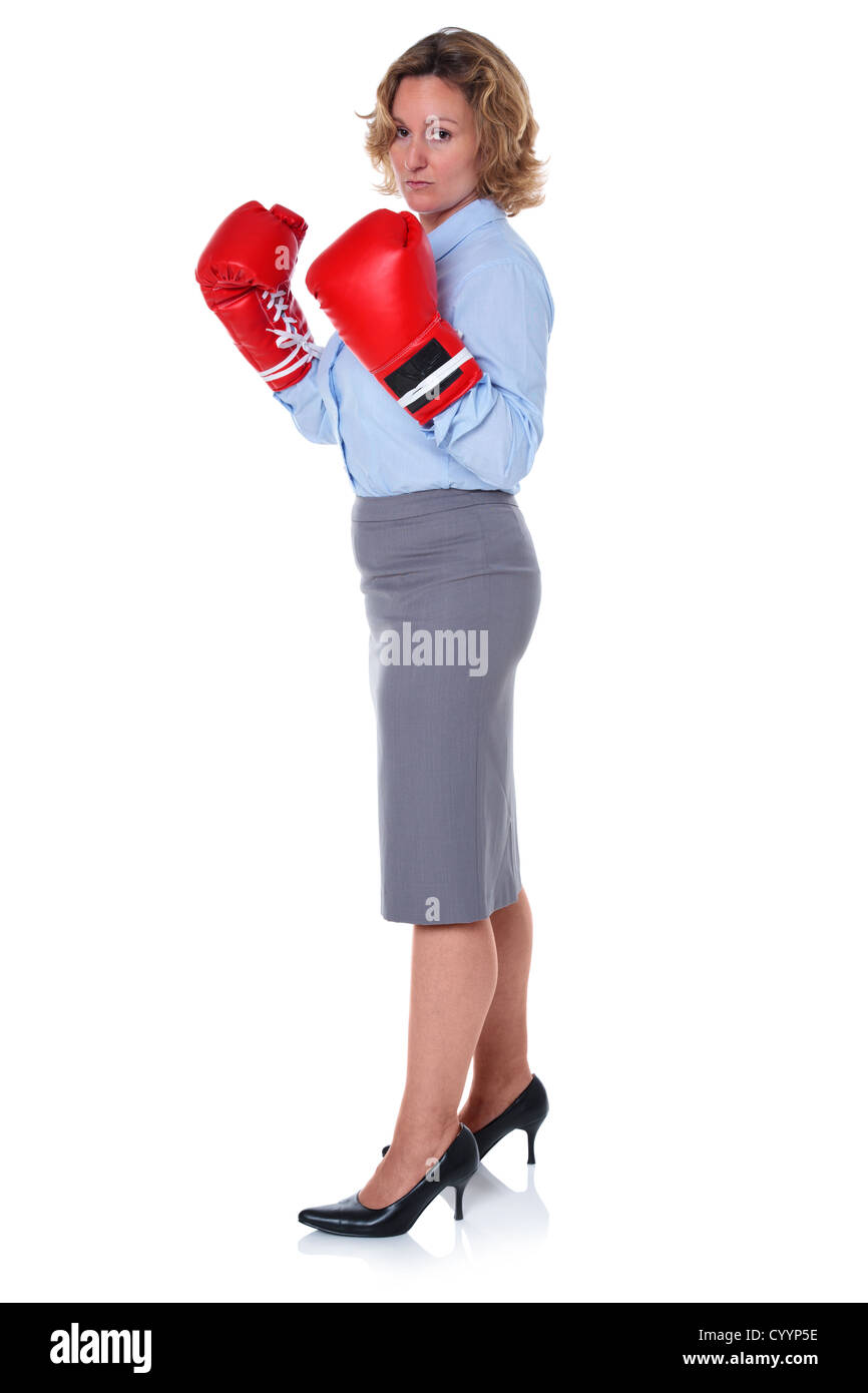 Photo of a businesswoman wearing boxing gloves, isolated on a white background. Stock Photo