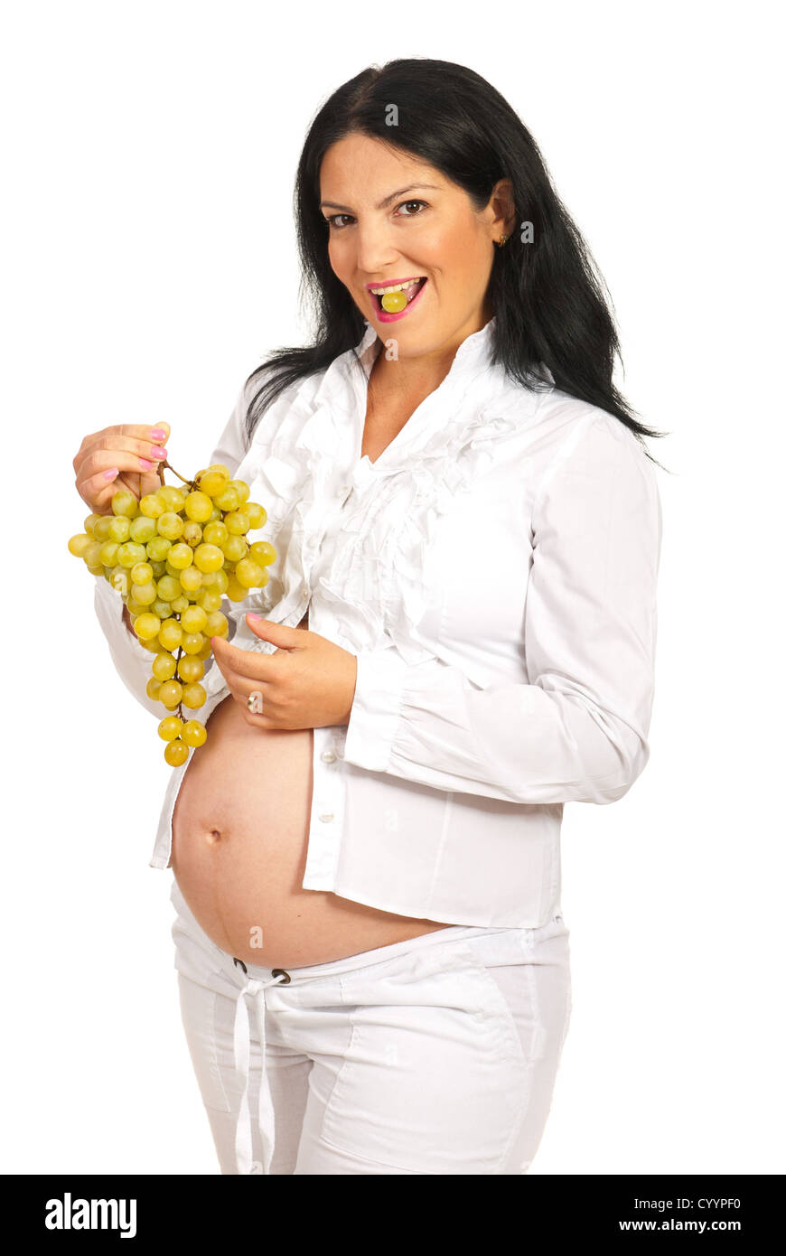 Happy pregnant eating white grapes isolated on white background Stock
