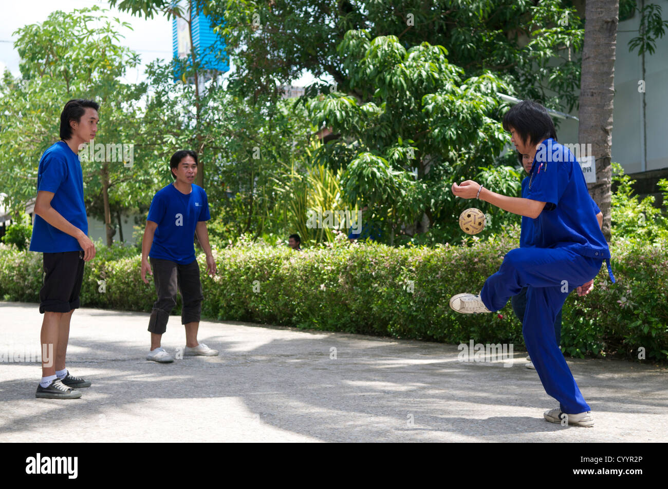 Thai staff playing Sepak takraw Stock Photo