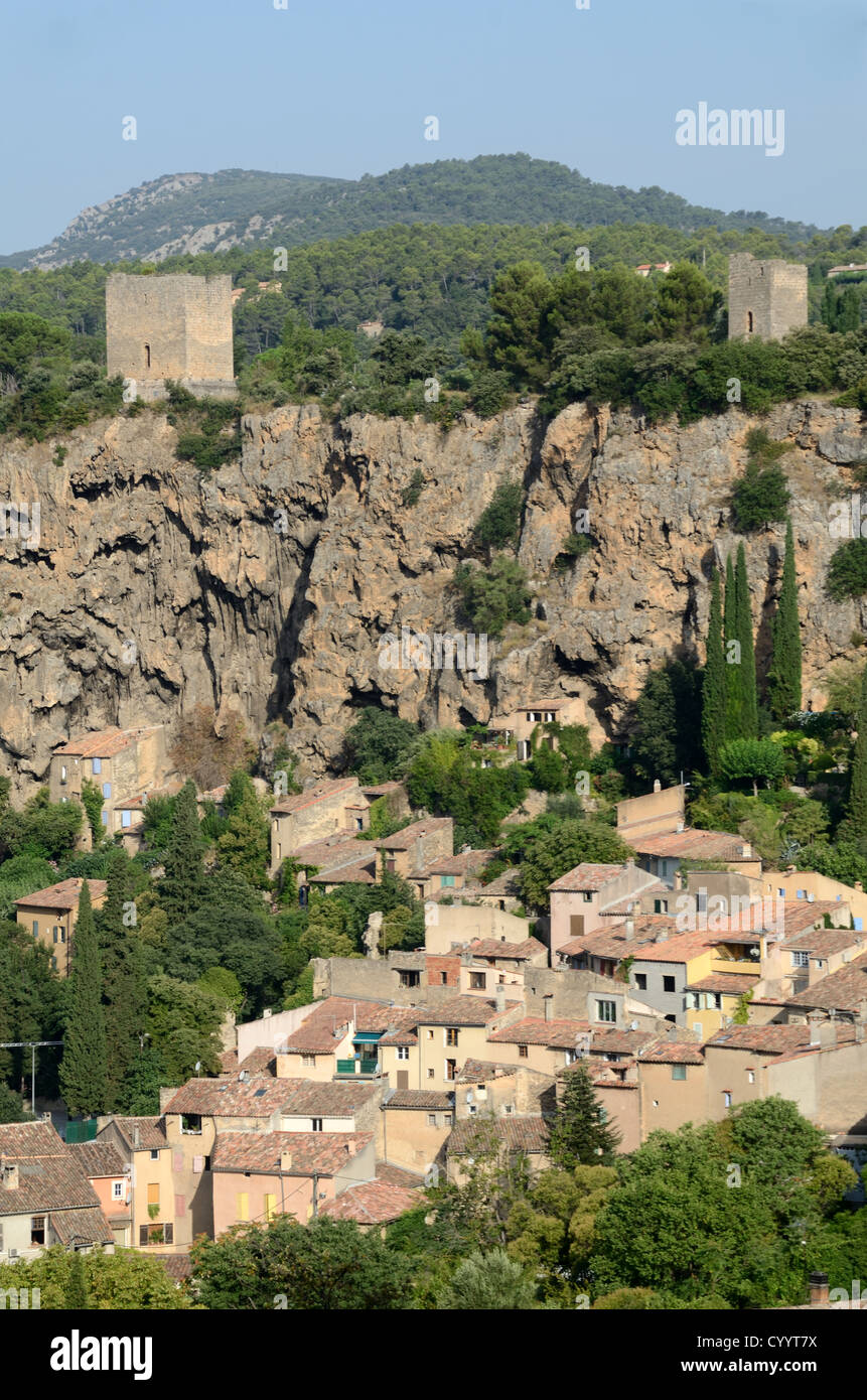 Aerial View or High-Angle View over the Village Houses of Cotignac with its Cliff, Troglodyte Dwellings and Medieval Towers Provence France Stock Photo