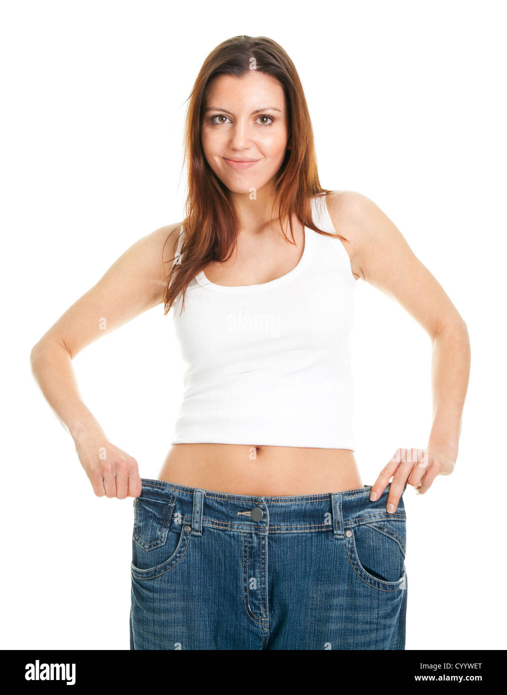 Slim woman pulling oversized jeans Stock Photo