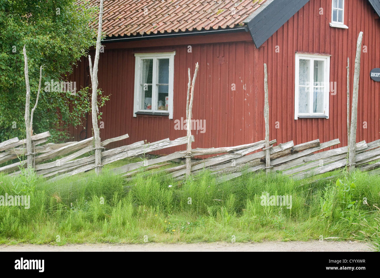 traditional red falun swedish house summer home houses summerhouse summerhouses rural iron ore paint fence fences sweden Stock Photo