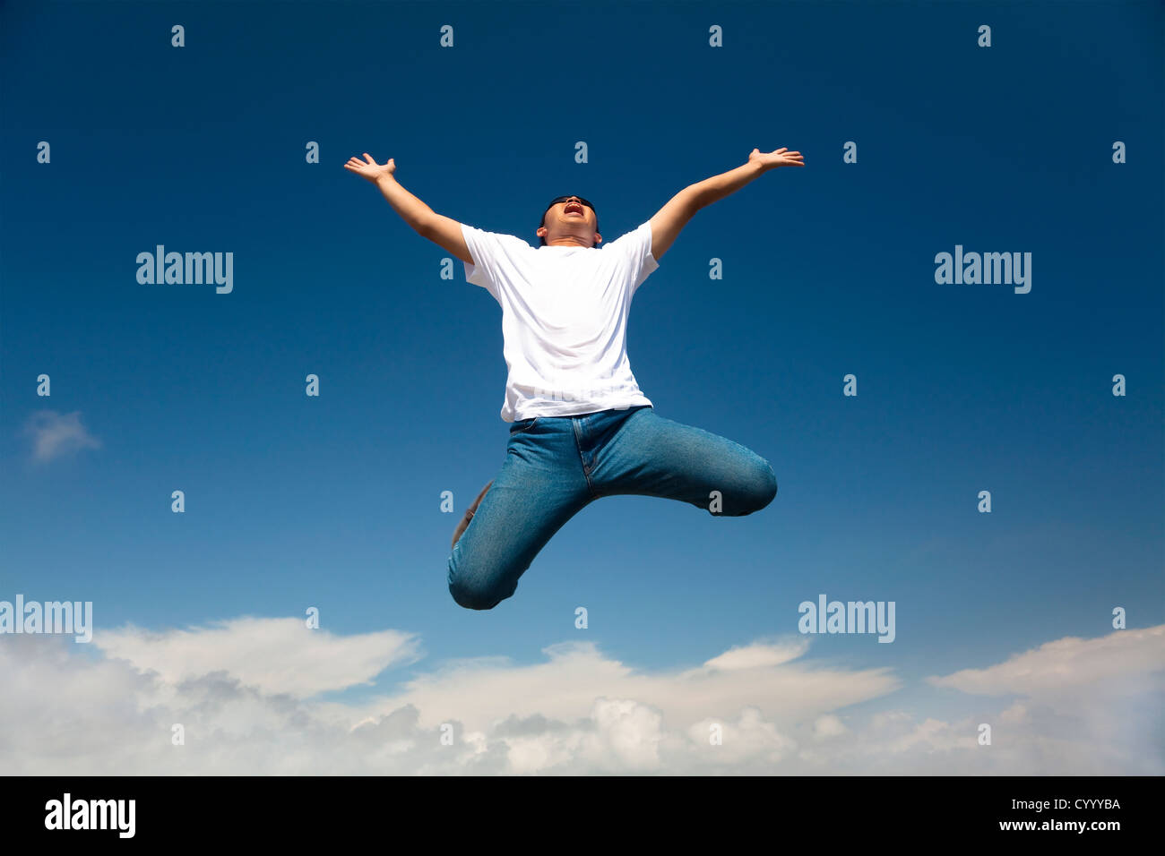 Happy man jumping with  blue sky background Stock Photo