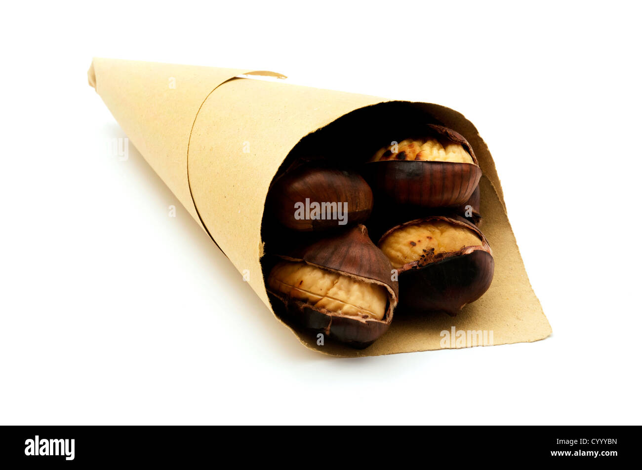 Roasted chestnuts in a paper cone on a white background Stock Photo