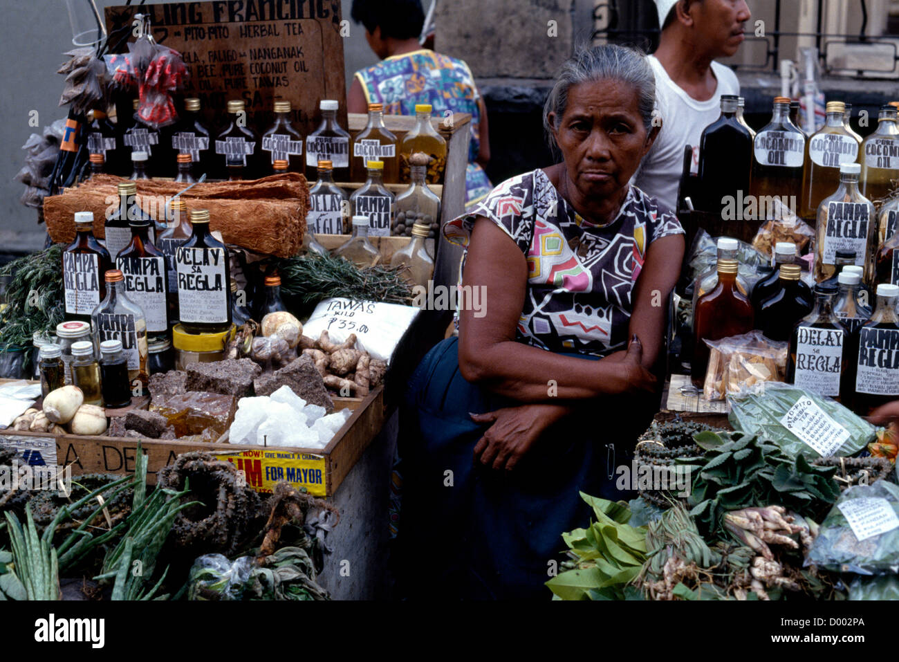 Woman selling various medicines on market stall. Asian El Filipinas Southeast Asia Female Women Girl Lady Stock Photo