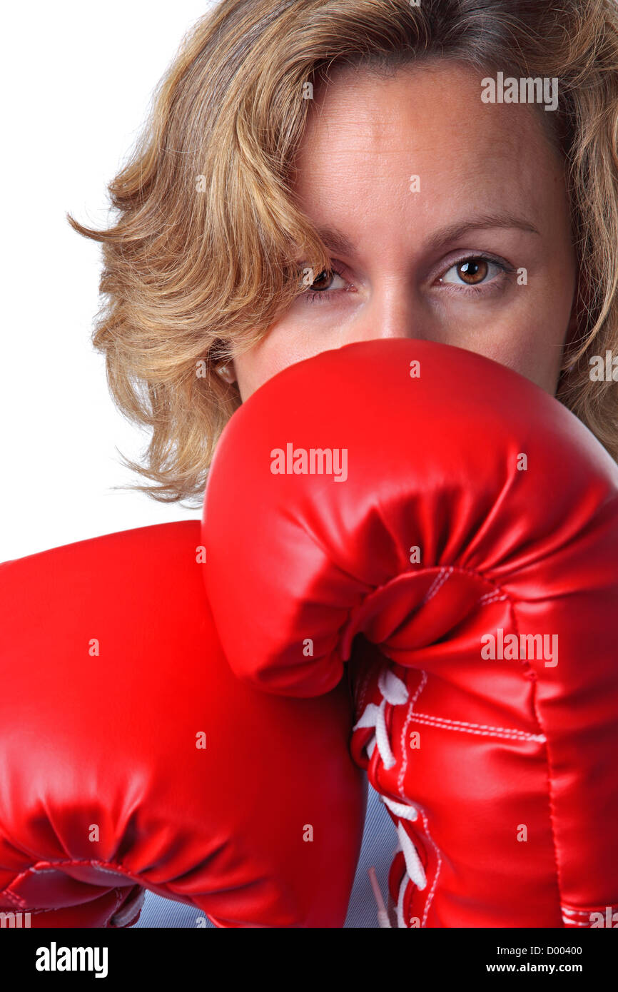 Close up of a woman who is weaing boxing gloves, white background. Stock Photo