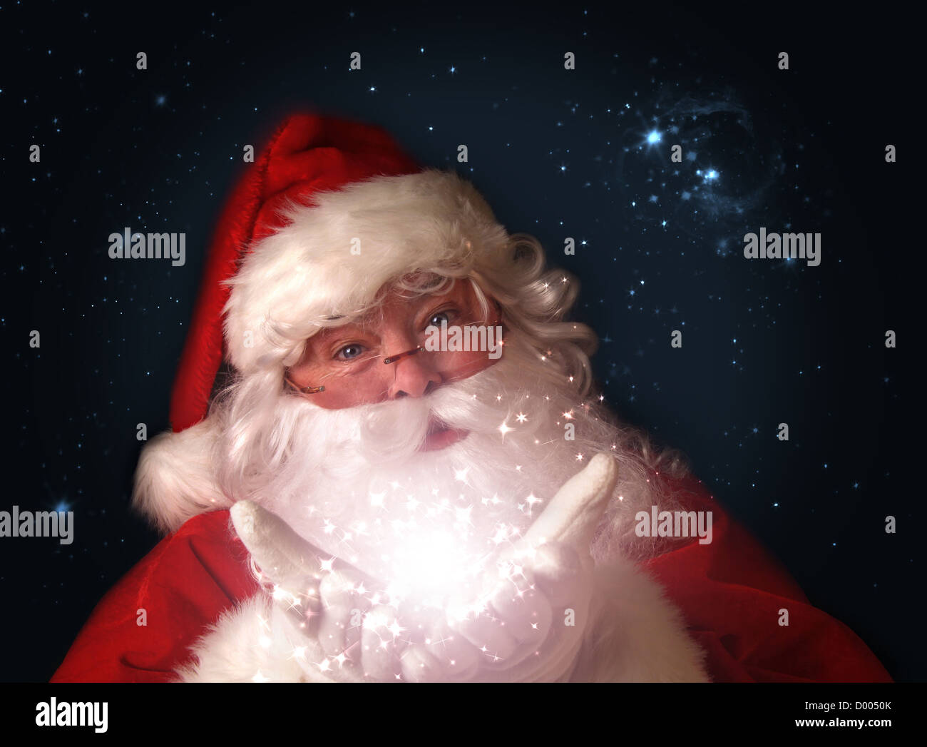 Santa holding magical christmas lights in hands Stock Photo