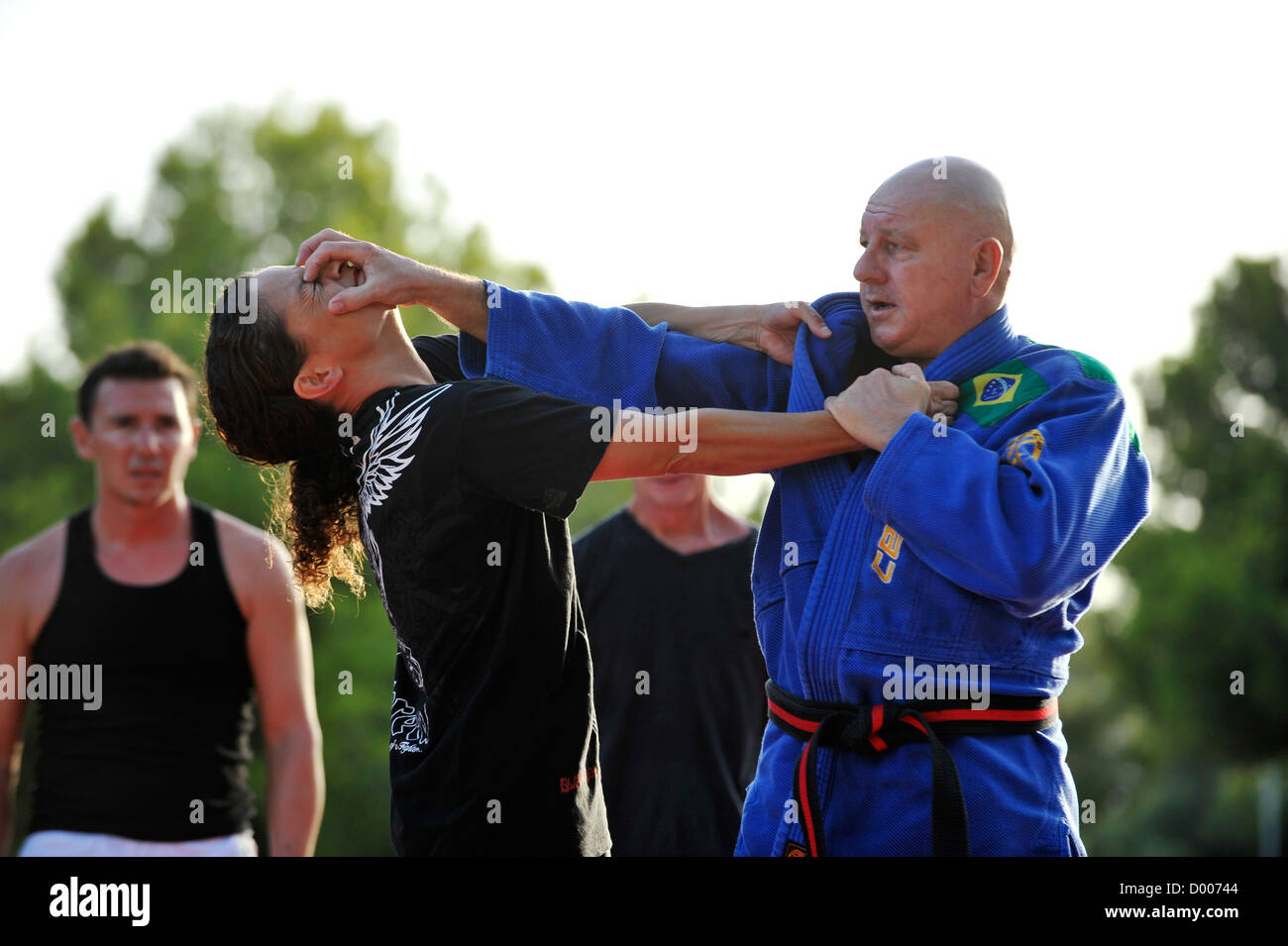martial arts teacher demonstrates selfdefense grip on female student