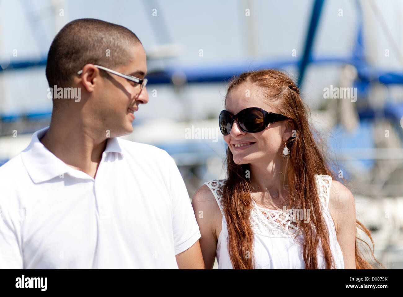 Happy young couple looking each other at the harbour Stock Photo - Alamy