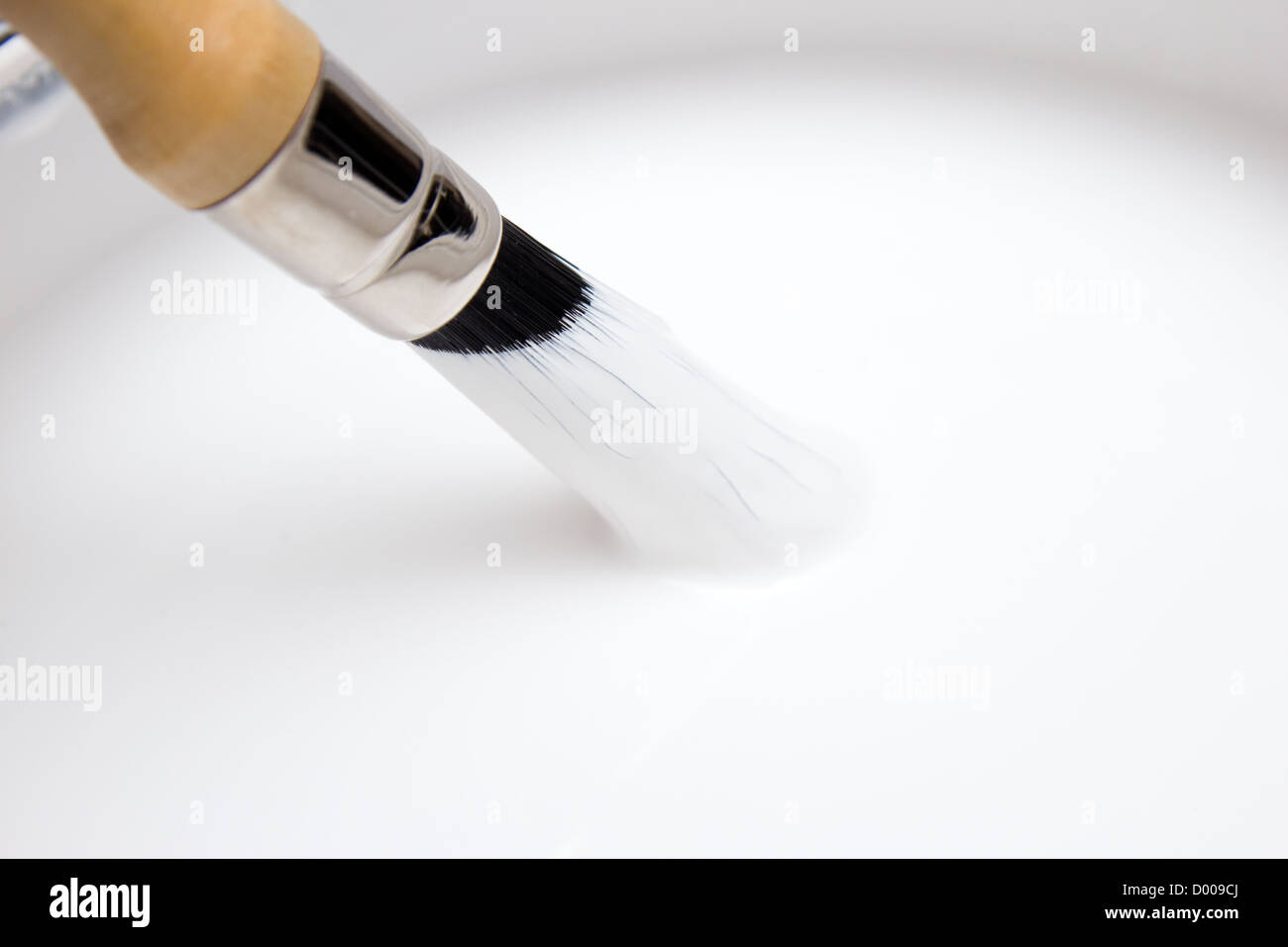 White paint with paintbrush Stock Photo