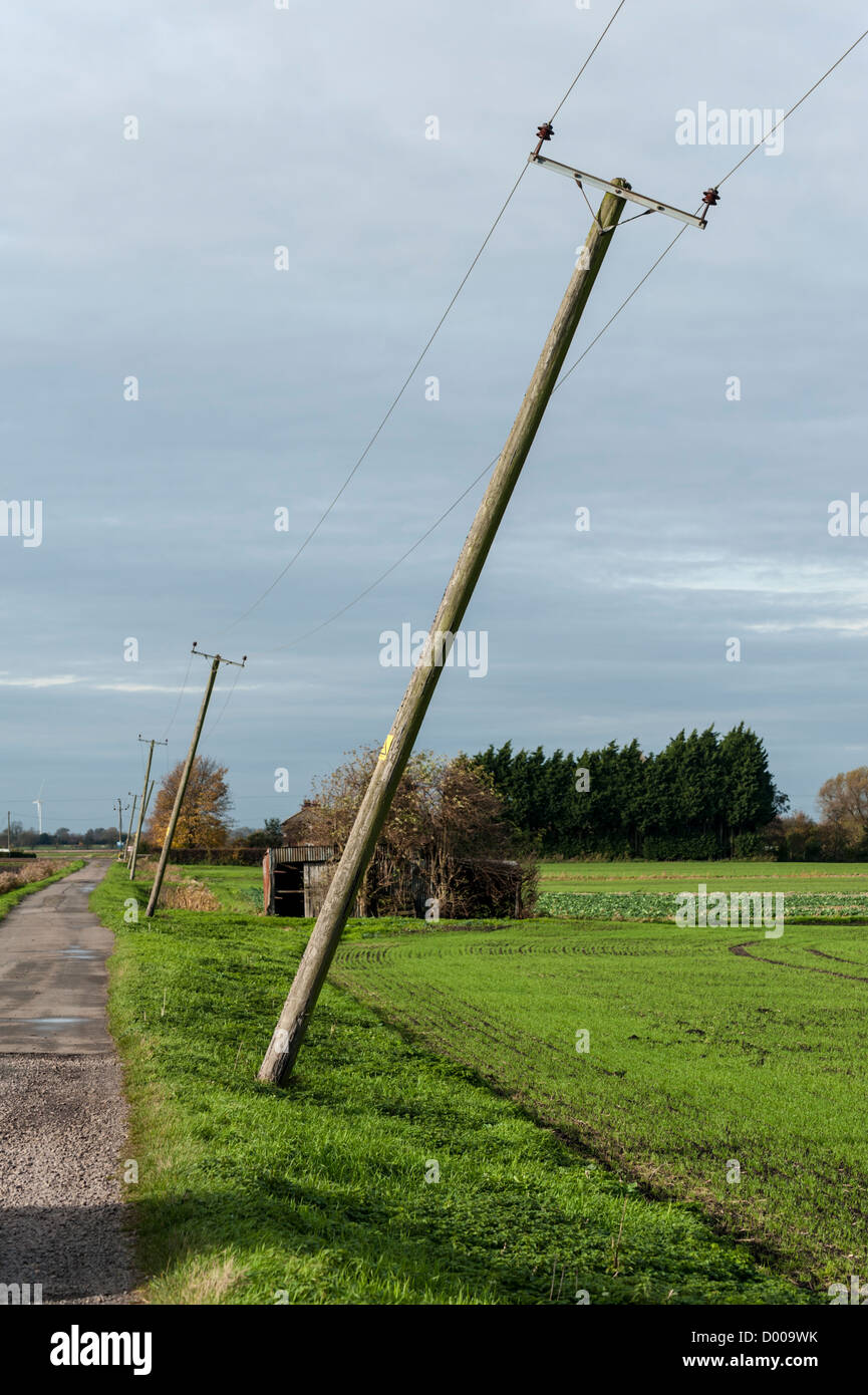 Telegraph poles leaning badly in the Cambridgeshire  Fens UK Stock Photo