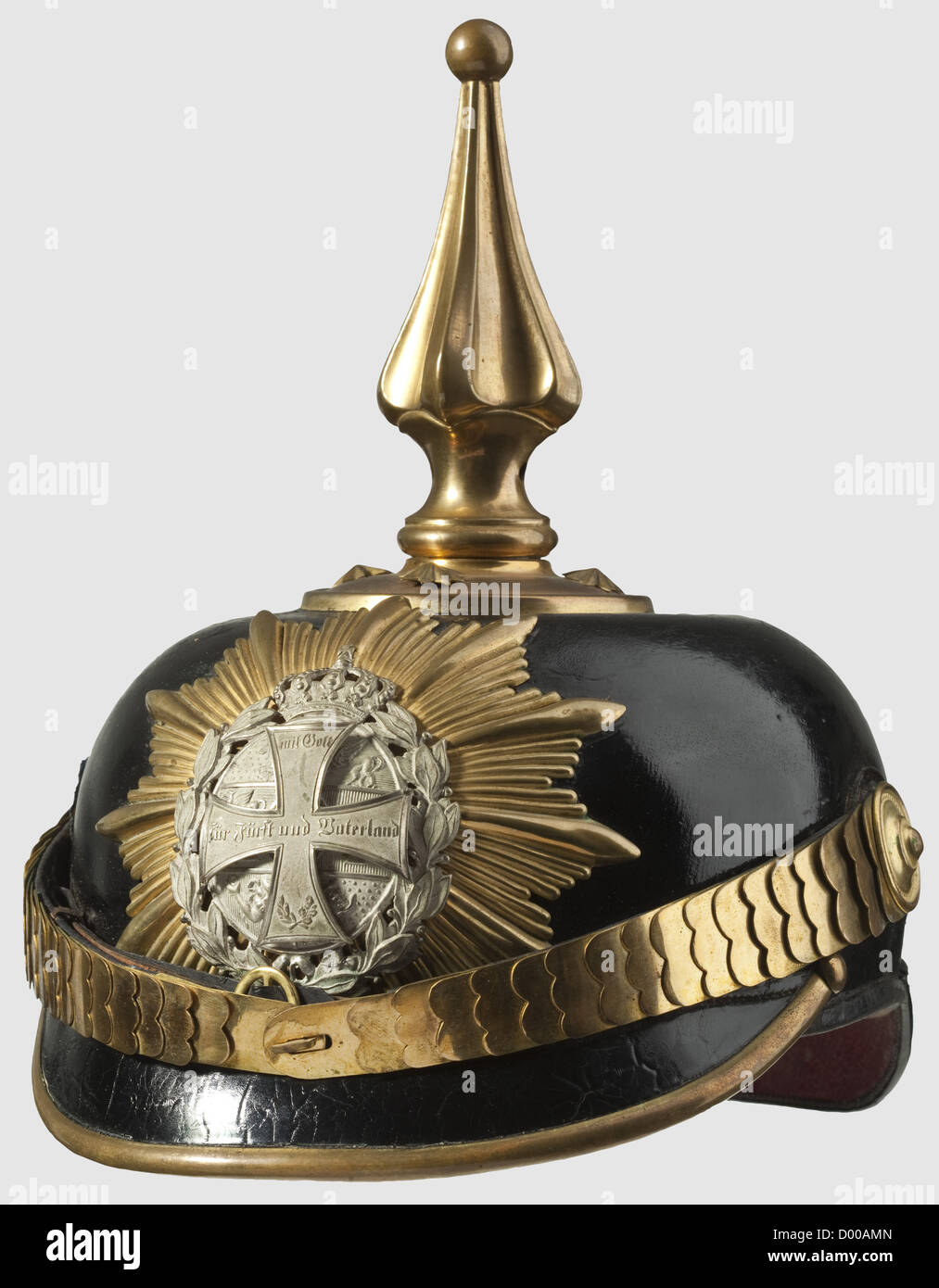 A helmet for officers of the Infantry Reserve or Medical Service,as worn until 1897.Leather skull with gilded mountings.The helmet spike is of the special Mecklenburg pattern with a turn-off ball finial.Silver-plated Mecklenburg arms displayed on the gilded star plate with a superimposed Landwehr cross,so mounted that it may be removed without a trace(no hole in the emblem).Flat metal chinscales.Silk national cockade on the right side.Ribbed silk lining with the owner's name 'Dr.Holm'.Beautifully preserved,rare helmet,historic,historical,19th cen,Additional-Rights-Clearences-Not Available Stock Photo