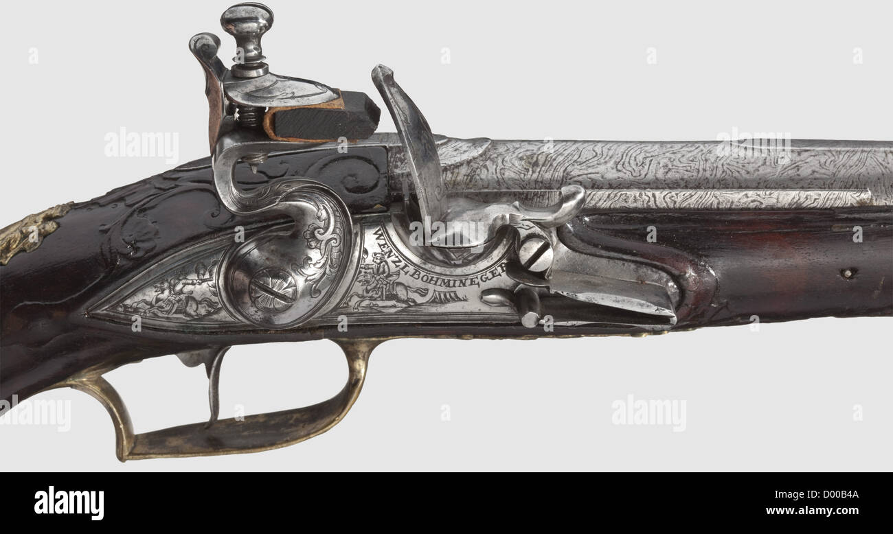 A flintlock pistol,Wenzl Böhm in Eger,circa 1740.Round smooth-bore Damascus barrel in 13.5 mm calibre with midrib and silver 'spider' front sight.The flintlock finely engraved with floral decorations and horsemen,beneath the powder pan signed 'WENZL BÖHM IN EGER'.Carved walnut stock with horn nose.Gilt brass furniture with rocaille decorations and soldiers in relief.Wooden ramrod with horn tip.Length 39 cm.High-quality pistol,except for a small crack underneath the lock as well as two tiny cracks on the forestock in good condition.Wenzl Böhm,Eger,,Additional-Rights-Clearences-Not Available Stock Photo
