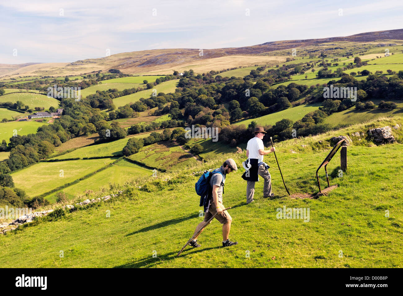 Walkers in the Brecon Beacons National Park, Wales, UK. East from Carreg Cennen castle over hill farm toward the Black Mountain Stock Photo