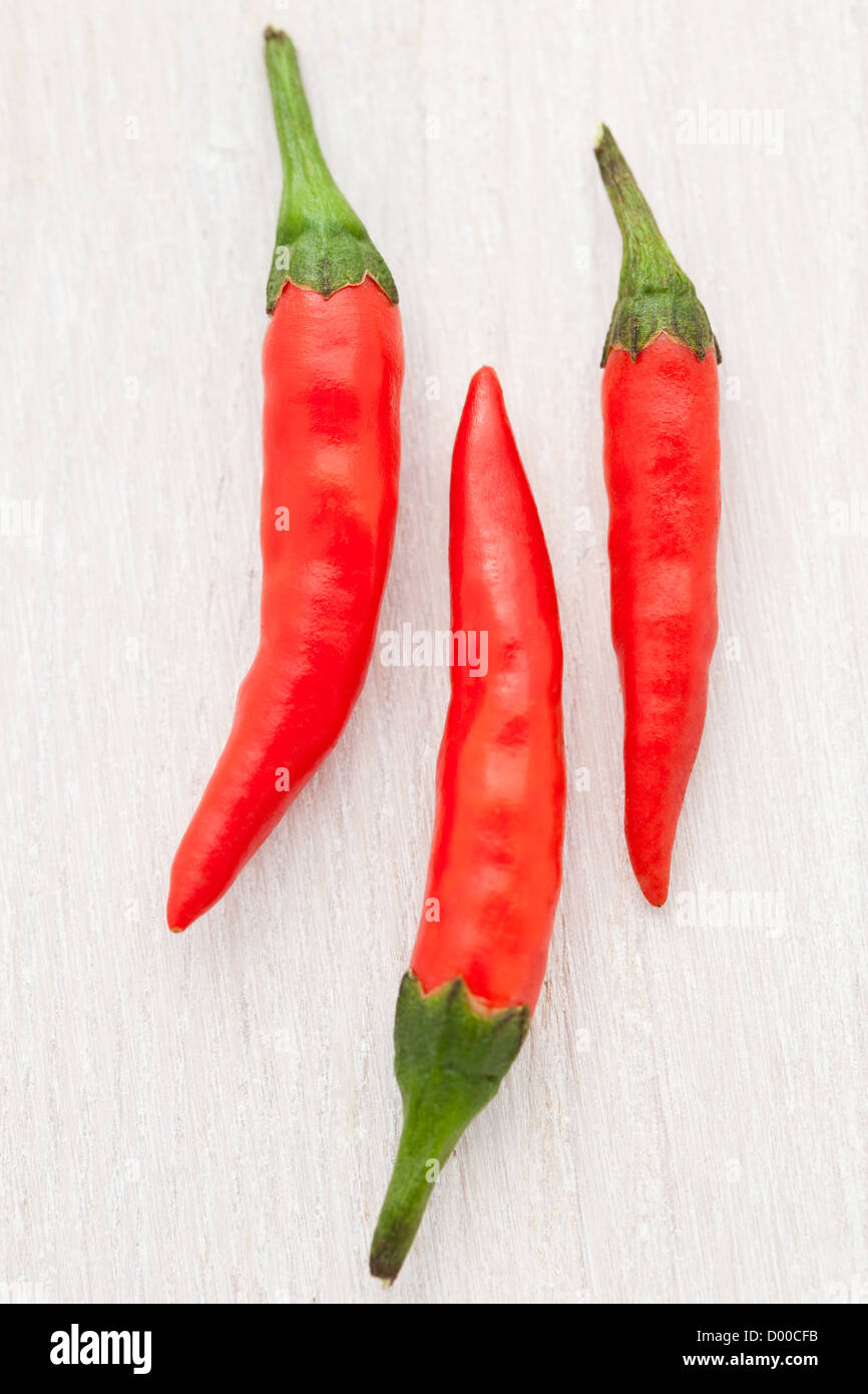 Hot chili peppers on a white wooden board Stock Photo - Alamy