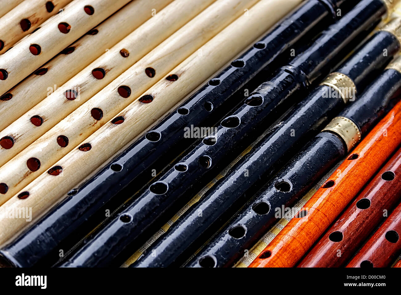 Whistles made from different types of wood and colored Stock Photo Alamy