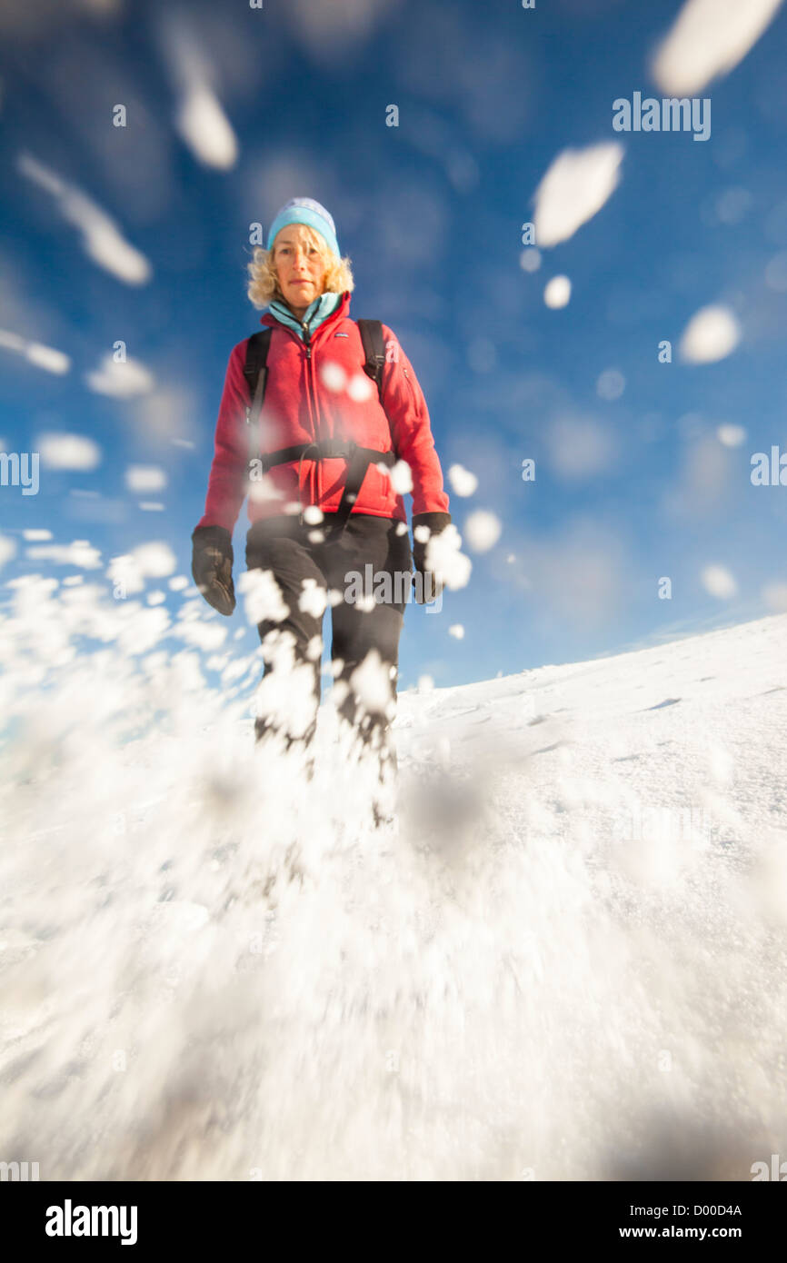 Woman walking on snow mountain hi-res stock photography and images - Alamy