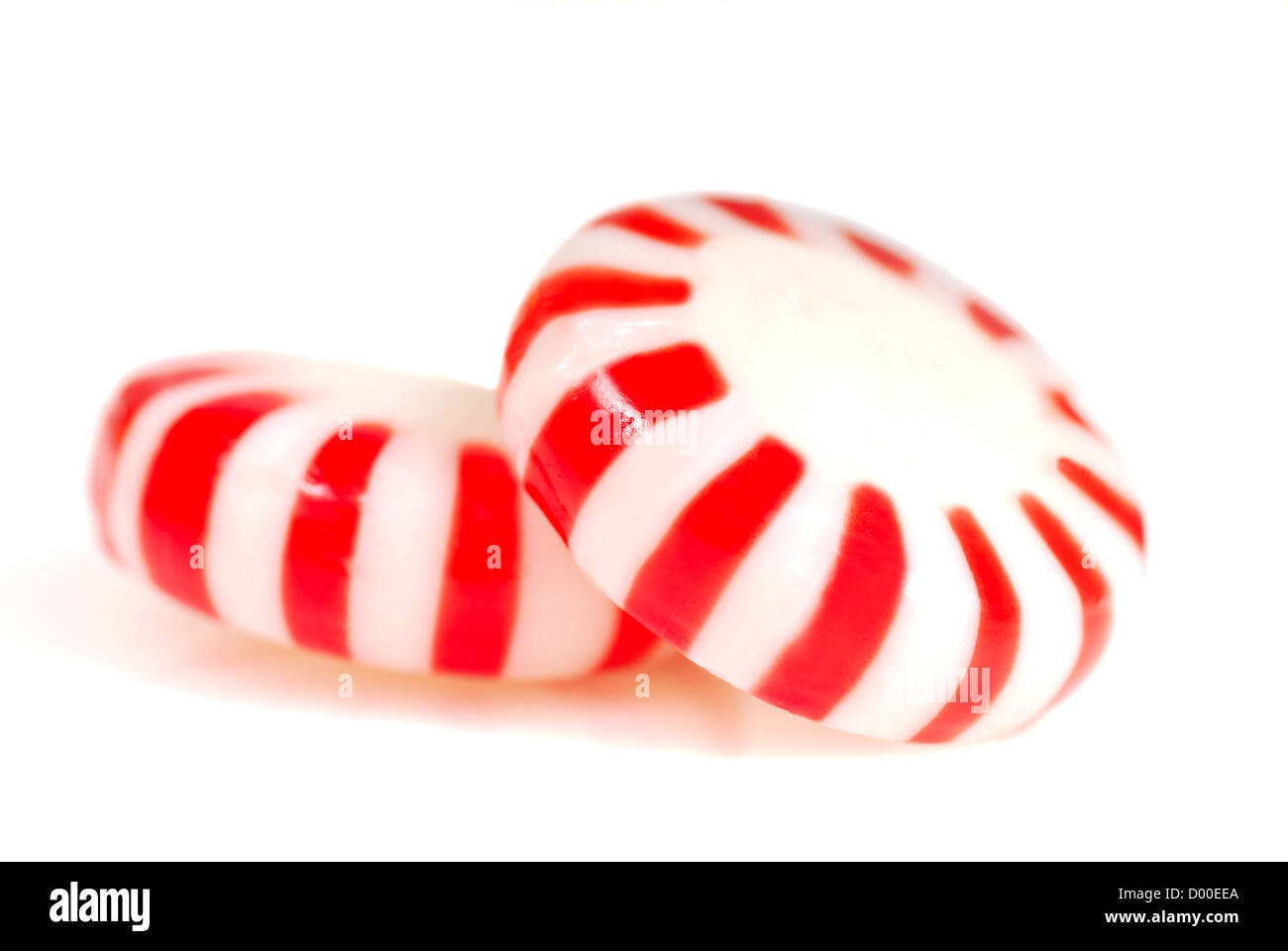 Two pieces of red and white peppermint Christmas candy Stock Photo