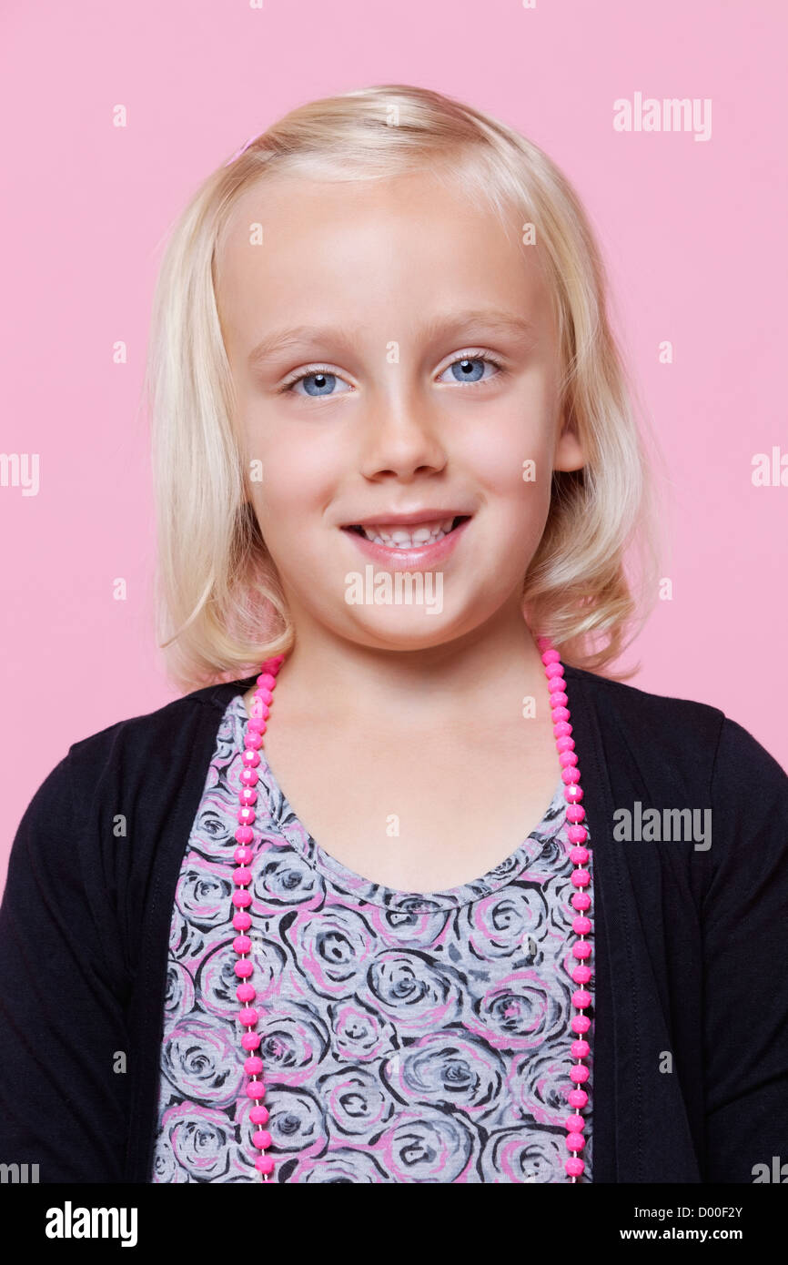 Portrait of a happy young girl over pink background Stock Photo - Alamy