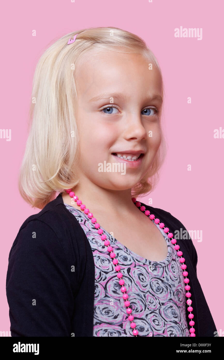 Portrait of a happy young girl over pink background Stock Photo - Alamy