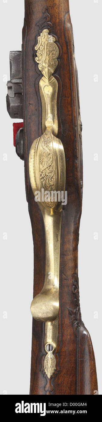 A flintlock shotgun,Russian.Beckmann,St.Petersburg,circa 1800.Two-stage barrel,octagonal then round after a cut and gilt girdle,with smooth bore in 20.5 mm calibre and patent breechblock.Silver-mounted muzzle and silver front sight,over the breech the gold-inlaid signature 'BECKMANN ST PETERSBURG'.Gold-bushed vent hole as well as gold-inlaid breech plug.Cut flintlock with floral gold inlays and gold-lined pan as well as frizzen on rollers,the lockplate with repeated signature.Beautiful,florally carved walnut full stock with patchbox and horn nose,Additional-Rights-Clearences-Not Available Stock Photo