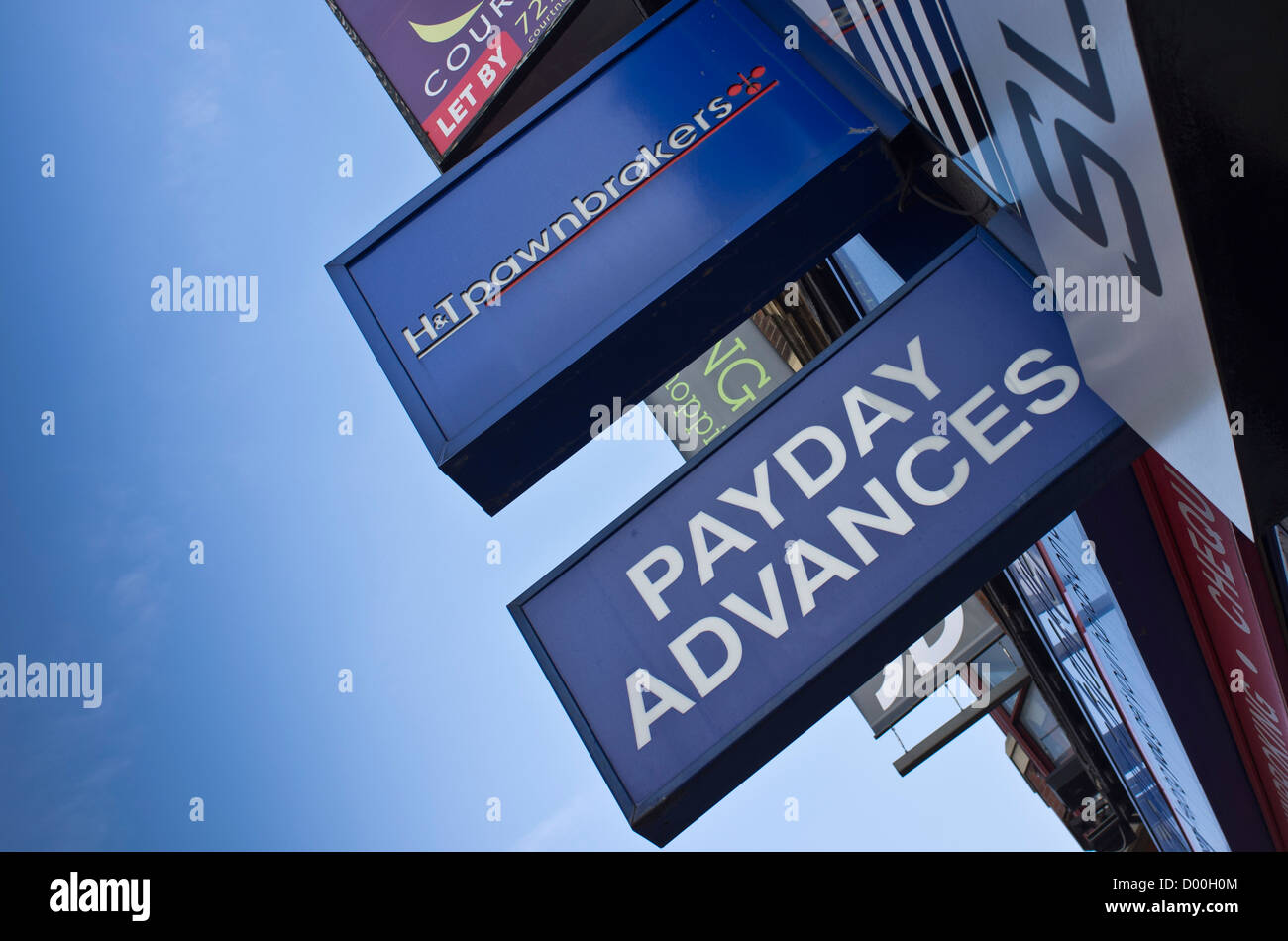 High street signs for the cash loans, payday advances and pawnbroker shops in Dalston, London, UK. Stock Photo