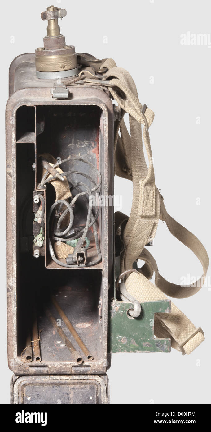 A field radio set C,of 1941 with brown Bakelite housing(damaged and repaired). Original cloth grip,web attachment belt of British origin,metal carrying frame built later. Inside,a riveted-on identification plate 'Nr. 003481 byi 41' and operating instructions for field radios B and C,the 'Feind hört mit' plate missing. A copper antenna in four sections is included(socket and antenna not of model type). Functionality and completeness not verified. Dimensions 35 x 33 x 12 cm,historic,historical,1930s,20th century,intelligence corps,military,militaria,Additional-Rights-Clearences-Not Available Stock Photo