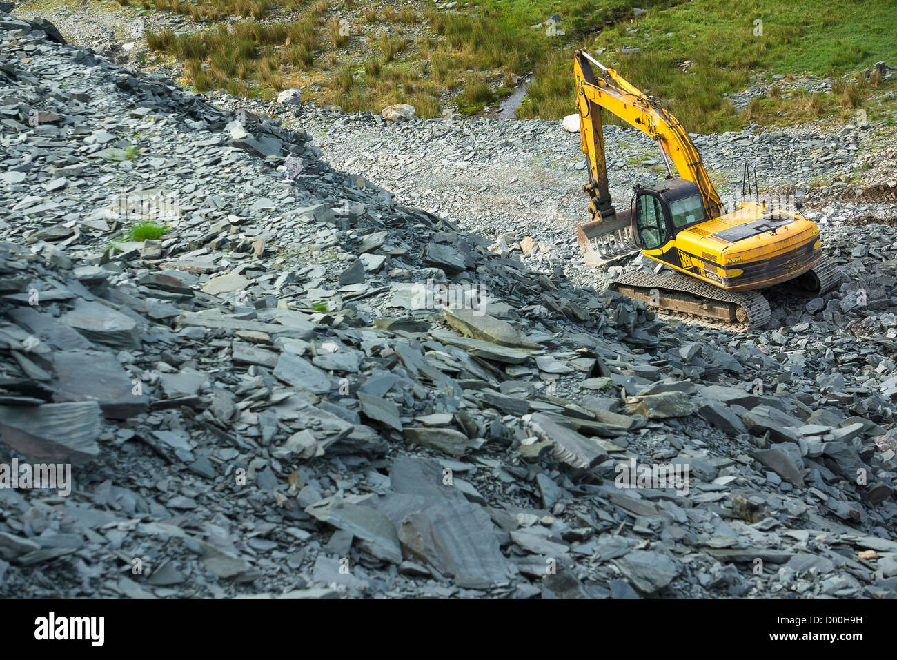 A large JCB digger at Honister Slate Mine in the Lake District Stock Photo
