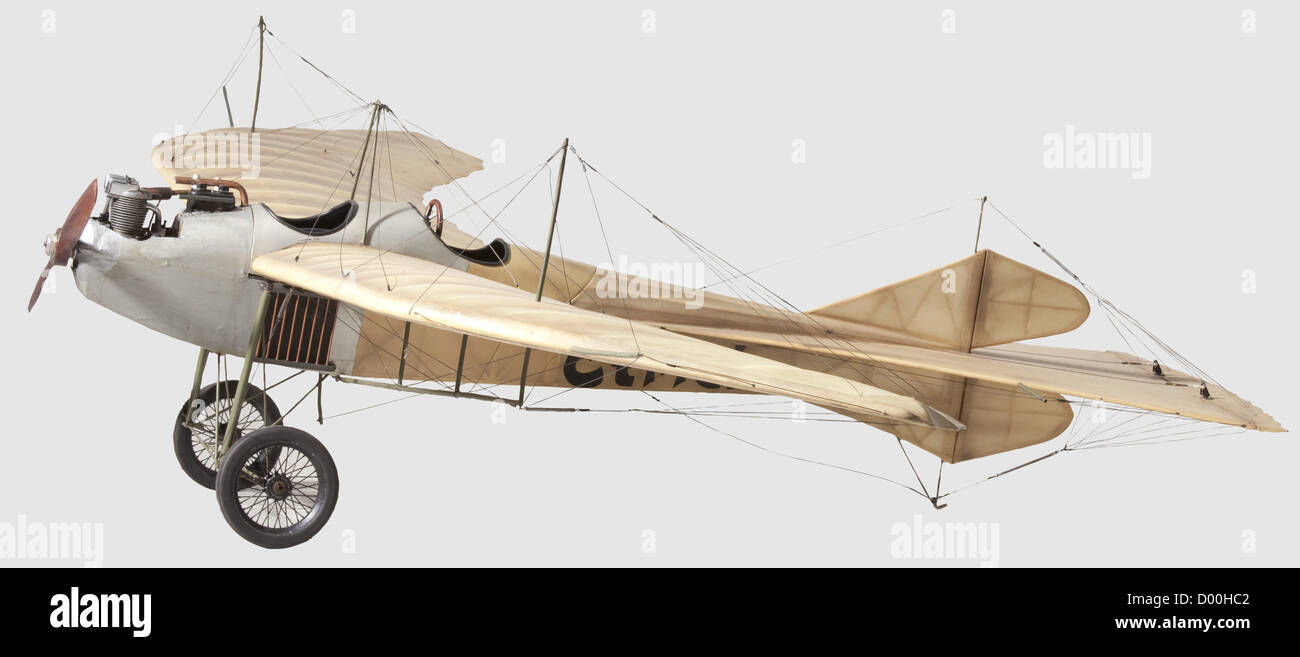 An Etrich 'Taube'(Dove),A flying scale model of this famous World War One fighter monoplane,the balsa-wood airframe covered and finished in natural doped fabric with wing warping mechanism to the main-planes with supporting pylons,movable rudder and elevator,the underside of the main-planes painted in black with the Etrich logo,the forward fuselage with dummy lateral radiators,the rear cockpit with control wheel,the dummy 100 h.p.Argus engine mounted together with a 4-stroke miniature petrol engine driving a two-blade 43 cm diameter propeller,on strut,Additional-Rights-Clearences-Not Available Stock Photo