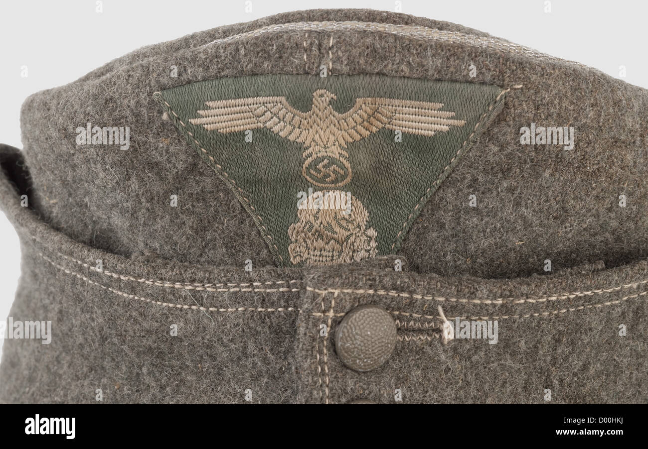 A peaked cap for leaders of mountain troops,of field grey woolen material with silver piping and field grey metal buttons,light linen liner(faded). BeVo national badge in trapezoid shape,silver-grey weave on a field grey background. Machine-embroidered Edelweiss,historic,historical,1930s,1930s,20th century,Waffen-SS,armed division of the SS,armed service,armed services,NS,National Socialism,Nazism,Third Reich,German Reich,Germany,military,militaria,utensil,piece of equipment,utensils,object,objects,stills,clipping,clippings,cut out,Additional-Rights-Clearences-Not Available Stock Photo