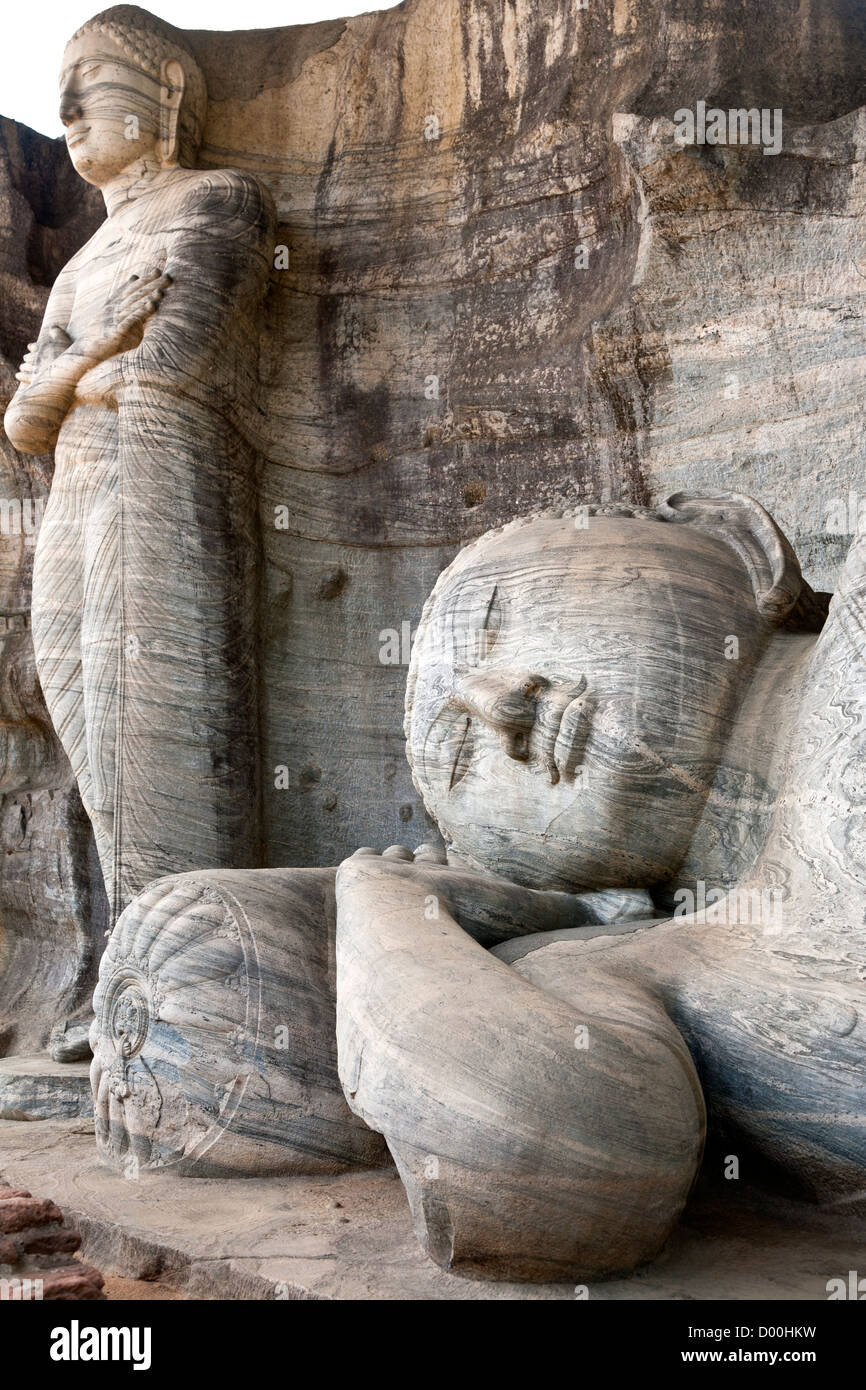 Reclining Buddha and standing Buddha carved on the rock. Gal Vihara. Polonnaruwa ancient city. Sri Lanka Stock Photo