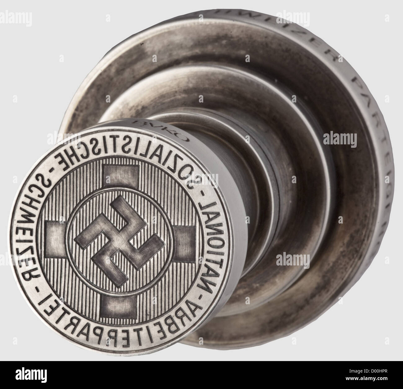 Jacques Buser-Kobler(BUKO)- a large silver seal of the NSSAP,Silver,made in two pieces. The seal surface cut with the NSSAP emblem,i.e. the National Front banner circumscribed 'National Sozialistische - Schweizer - Arbeiterpartei',laterally the artist's signature BUKO,stepped shaft,the top of the handle bearing a swastika within an oak leaf wreath in relief,the handle's perimeter inscribed 'Sieg Heil - Kampf Heil - den Schweizer Parteigenossen'. Height 78 mm,weight 280 g. Included is the Engelberg monastery padre's 1969 letter to the German collector,,Additional-Rights-Clearences-Not Available Stock Photo