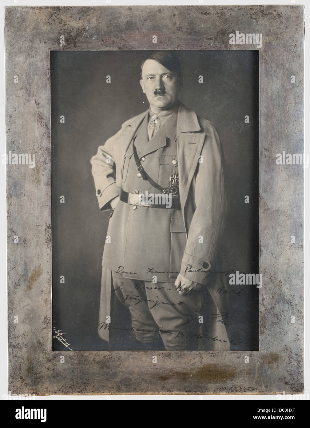 Jacques Buser - Kobler (BUKO) - a dedication photo in silver frame presented by Hitler to BUKO in 1935, Large format Hoffmann Portrait (aprox. 22.5 x 15.5 cm / slightly trimmed) with superimposed photographers' signature on the left side. Hitler in party uniform with Iron Cross 1st Class and Wound Badge in Black. The lower right with handwritten dedication in ink 'Dem treuen Parteigenossen J. Buser - Kobler, Basel zugeeignet - Adolf Hitler - München den 14/Oktober 1935' (To the loyal Party Member…). Mounted in a plain silver glazed frame with stand on the rever, Stock Photo
