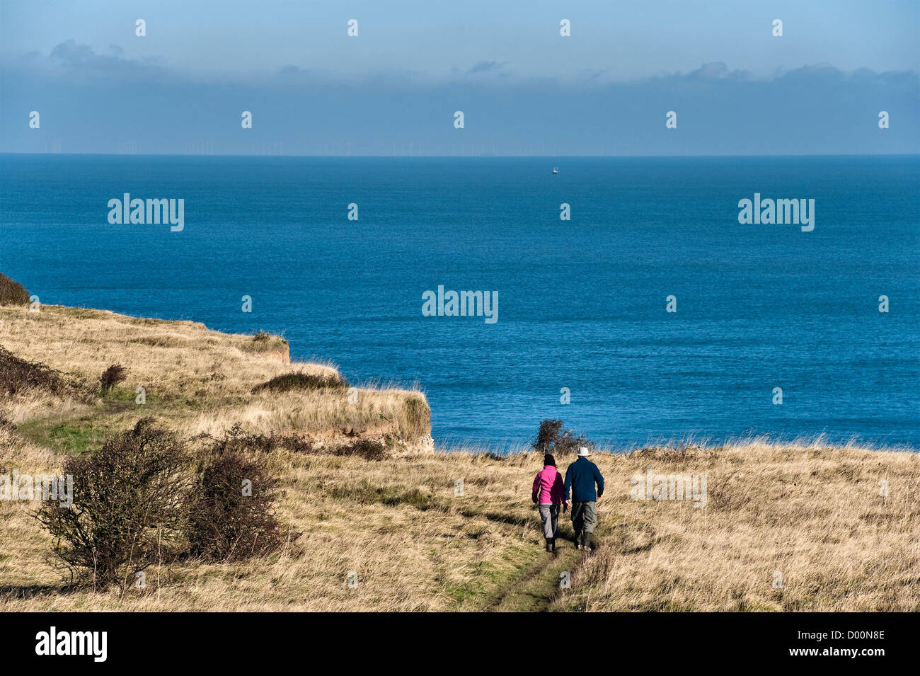 Walkers on the Kent coastal path (the Saxon Shore Way) above the White Cliffs between Deal and Dover, winter (UK) Stock Photo