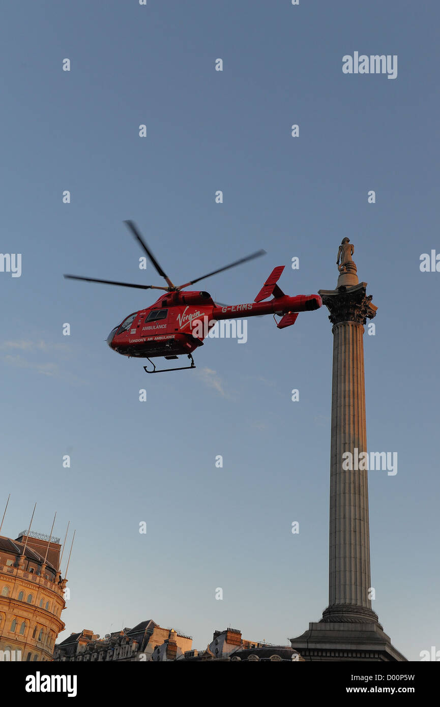 LONDON. UK. 21/03/2012. London Air Ambulance helicopter HEMS flies out of Trafalgar Square Stock Photo
