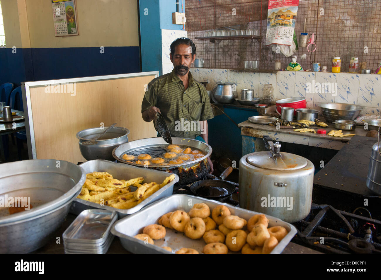 Man frying snacks in the kitchen of a roadside restaurant, Ambalappuzha, near Alappuzha