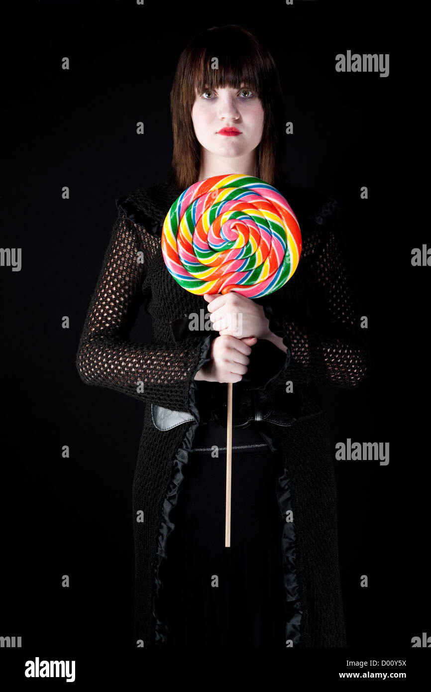 Pretty emo girl with bright colorful lollipop Stock Photo