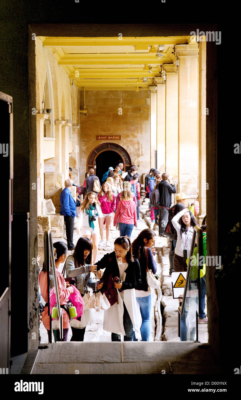 A crowd of tourists seen through a doorway at the Roman baths, Bath Somerset UK Stock Photo