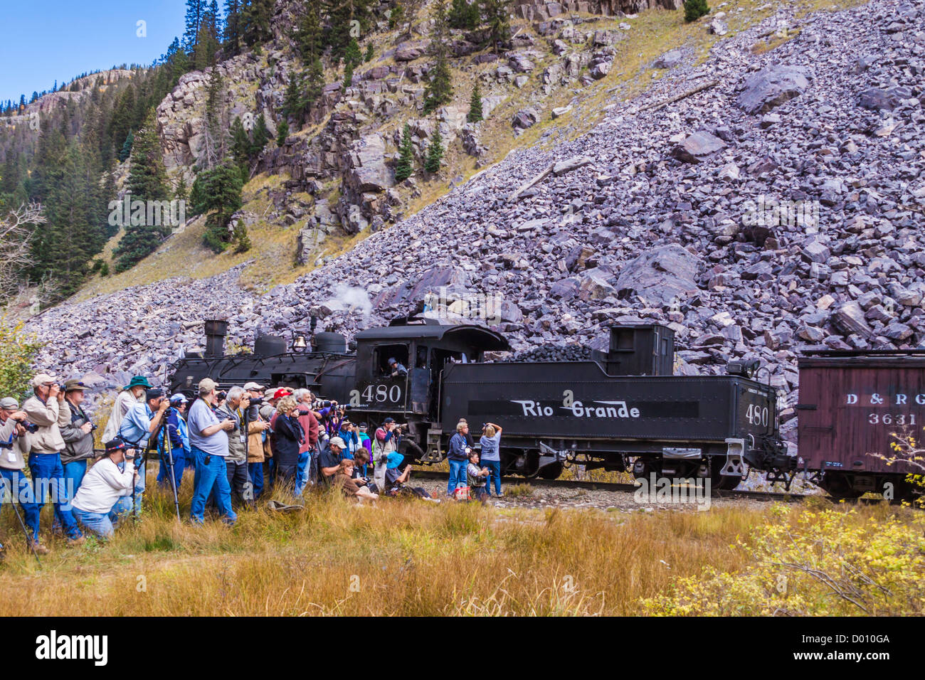 Photographers shooting runby of photo train with 1925 Baldwin 2-8-2 steam locomotive and mixed consist train at Needle Creek. Stock Photo