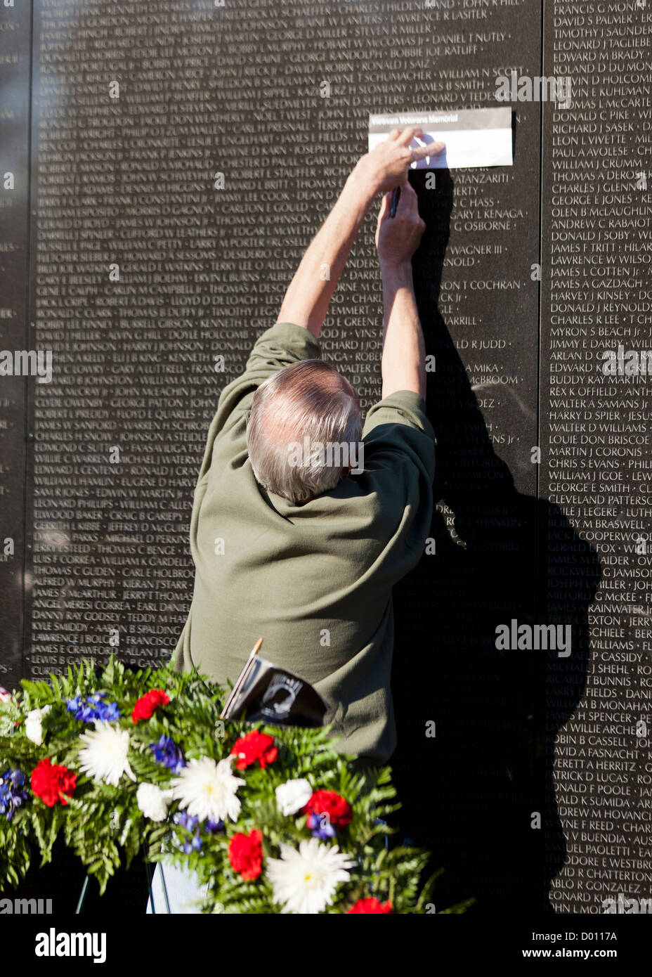 A Vietnam veteran getting a rubbing of a name from the Vietnam War
