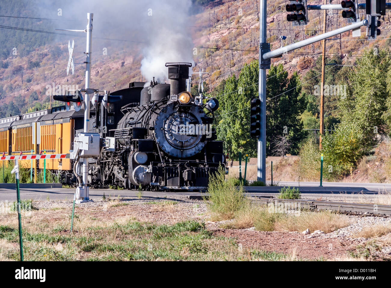 1925 Baldwin Steam Locomotive, 2-8-2 configuration, Mikado type, pulling historic antique railcars on the D&SNG Railroad at Trimble Crossing. Stock Photo