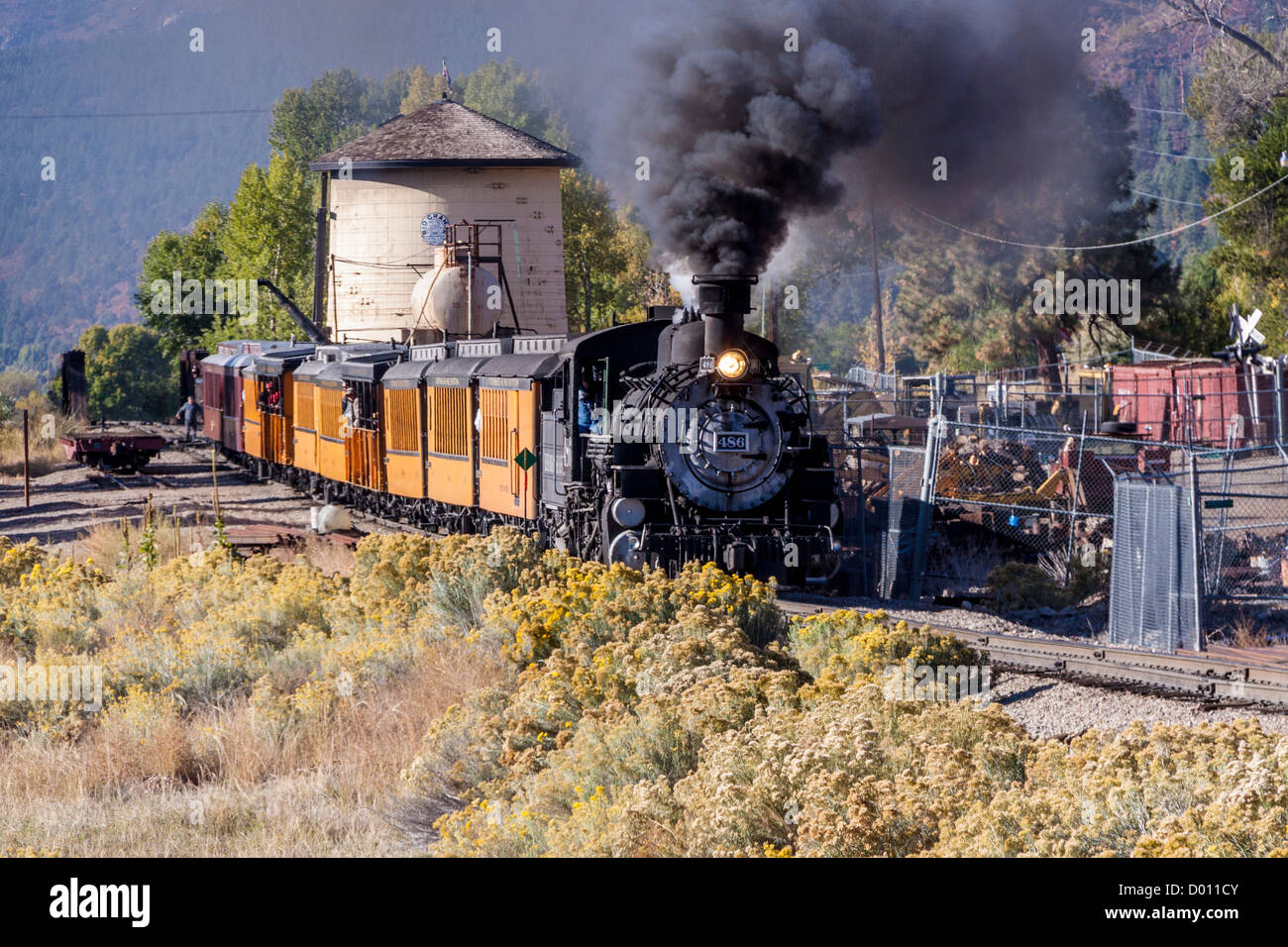 1925 Baldwin Steam Locomotive, 2-8-2 configuration, Mikado type, passing Water Tower at Hermosa, Colorado, on the D&SNG Railroad route. Stock Photo