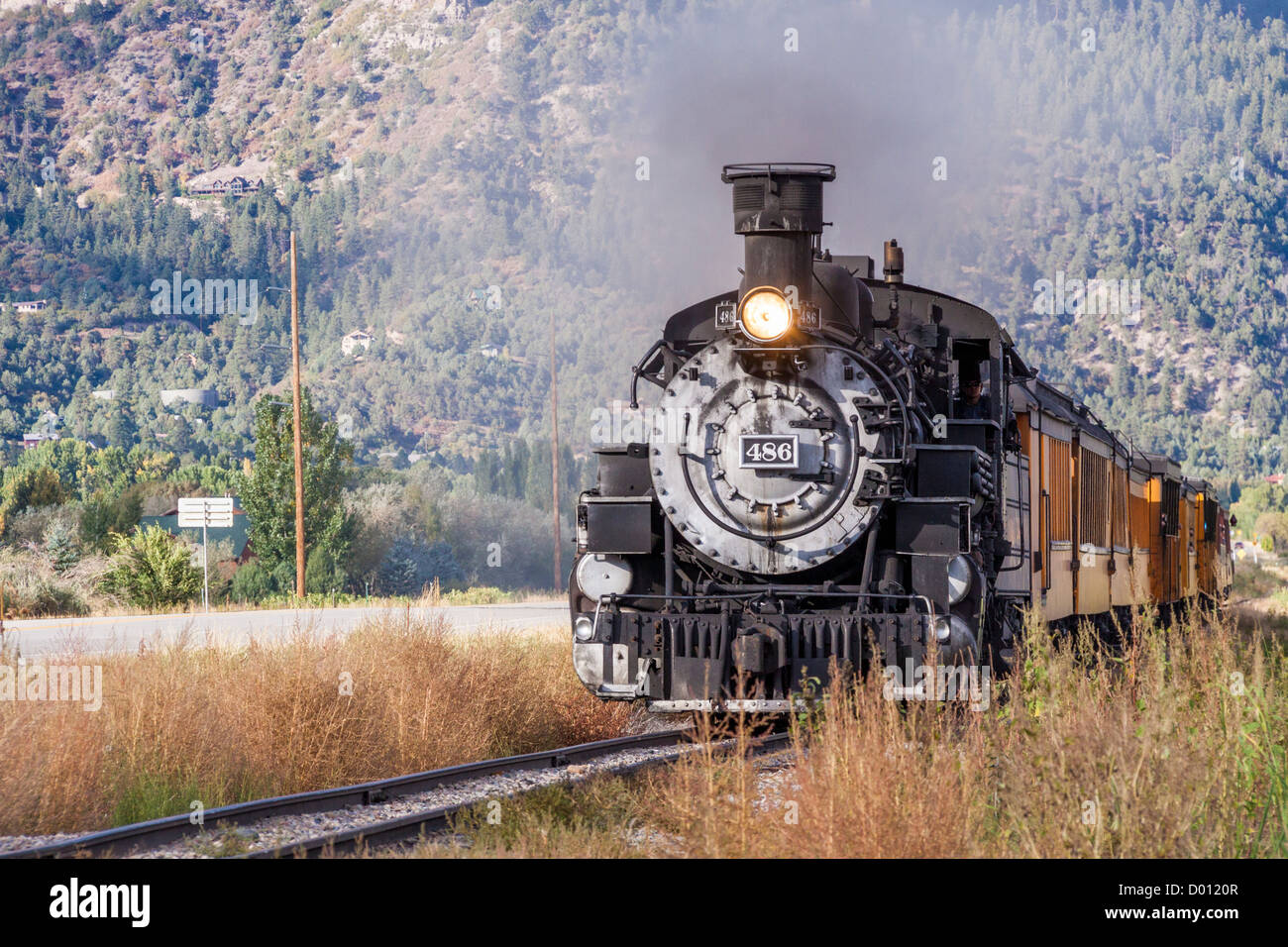 1925 Baldwin Steam Locomotive, 2-8-2 configuration, Mikado type, pulling historic classic railcars, at Trimble Crossing near Durango, Colorado. Stock Photo