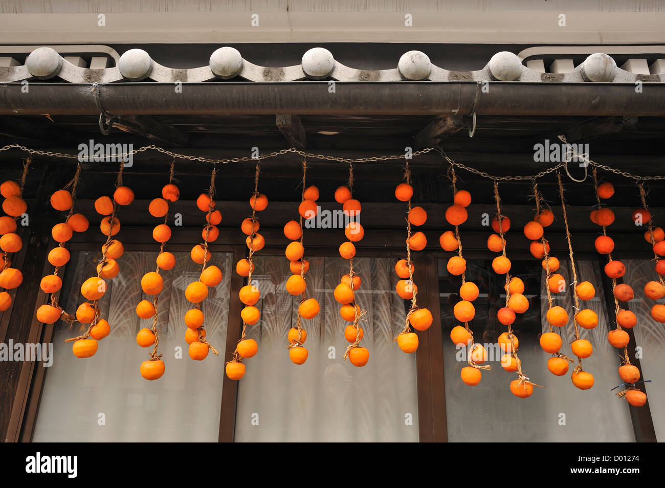 Persimmons or kaki hung up to dry in the sun in Hase, Sakurai, Japan Stock Photo